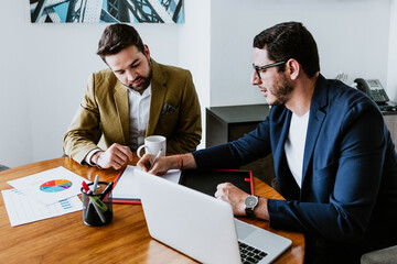 Wall Mural - young Latin men or couple of business colleagues working at office in Mexico Latin America, hispanic people at job