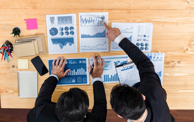 Poster - Top view analyst team discussing financial data on digital dashboard, analyzing chart and graph papers by data science software on wooden table background. Business intelligence and Fintech. Fervent