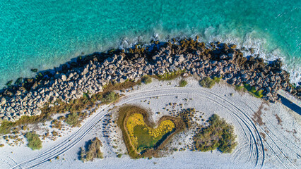 Wall Mural - Aerial view of love heart shaped island and sandy beach. Sunny day in summer with romantic tropical blue water. Travel to love beach, Western Australia. Top view. Coastal, Seascape