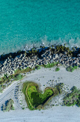 Wall Mural - Aerial view of love heart shaped island and sandy beach. Sunny day in summer with romantic tropical blue water. Travel to love beach, Western Australia. Top view. Coastal, Seascape