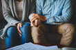 © Donson/peopleimages.com - Holding hands, senior couple and life insurance support with paperwork in a living room. Home, anxiety and elderly people with empathy, stress and trust with solidarity for bills and tax problem