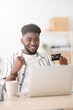 © Egoitz - Happy black man celebrating online purchase