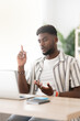 © Egoitz - African american young man talking on laptop