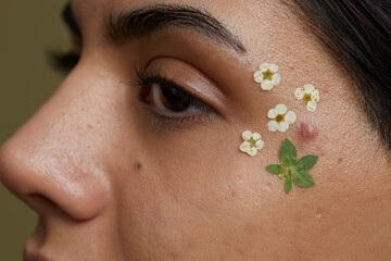 Wall Mural - Close-up of young woman face decorated with dried flowers