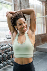 Wall Mural - Woman stretching arms in gym before training