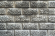 Building Exterior Roughly Textured Background,  Gray Porous Stone Wall With Holes