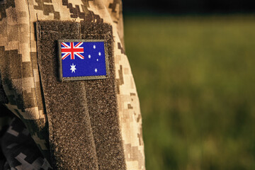 Wall Mural - Close up millitary woman or man shoulder arm sleeve with Heard Island and McDonald Islands flag patch. Troops army, soldier camouflage uniform. Armed Forces, empty copy space for text
