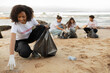 © Prostock-studio - Positive young multiracial people volunteers in rubber gloves and african american lady with trash bag clean up
