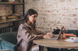 © Tatyana - Attractive positive young woman using a laptop in a cafe.Remote work,blogging,business, freelance,e-learning.
