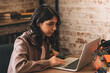 © Tatyana - Attractive young woman using a laptop in a cafe.Remote work,blogging,business, freelance,e-learning.