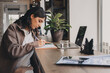 © Tatyana - Attractive young woman making notes in her notebook in a cafe.Remote work, business, freelance,online education.