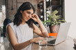 © Tatyana - Attractive positive young woman using a laptop in a cafe.Remote work,blogging,business, freelance,e-learning.