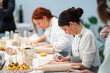 © ADDICTIVE STOCK - Focused women making clay products during class in studio