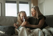 © Halfpoint - Senior woman taking care of her sick granddaughter.