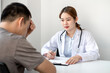 © nBhutinat - The doctor is explaining the treatment method to the male patient in the hospital.