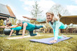© Davide Angelini - Sporty senior women doing exercise in garden during group training - Mature female exercising  hands and knees balance outside - Healthy life style concept