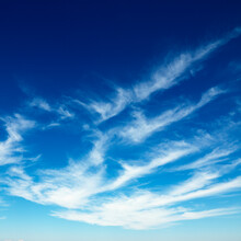 Wispy Cirrus Clouds In Blue Sky.