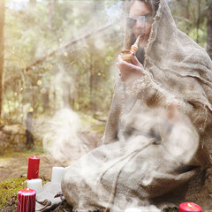 Wall Mural - A man in a cassock spends a ritual in a dark forest