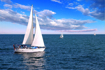 Canvas Print - Sailboat sailing in the morning with blue cloudy sky