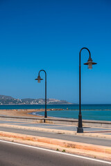 Wall Mural - Minimalist composition with a lantern on the promenade. A sunny warm day at a resort in Spain.