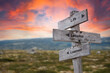 © Jon Anders Wiken - life lessons learned text quote on wooden signpost outdoors in nature. Pink dramatic skies in the background.