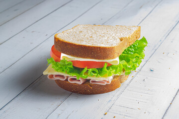 Wall Mural - Sandwich with Ham, cheese, lettuce, and tomatoes inside of a loaf bread