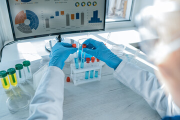 A medical worker performing tests on instruments in a chemical laboratory. a scientist conducting research in the laboratory to identify new treatments for infectious diseases.