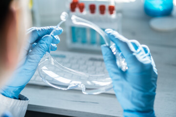 Poster - A chemist analyzes the results of an experiment with samples of various drugs on a computer in a medical laboratory.