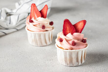 Homemade Cupcakes Decorated With Cream Cheese And Strawberries On A Gray Background