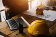 © ARMMY PICCA - Construction concept of Engineer and Architect working at Construction Site with blue print