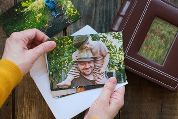 Photo printing, family memories. Woman looks at printed photos for family picture album.