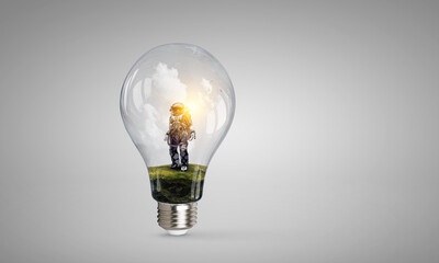 Wall Mural - spaceman inside light bulb . mixed media