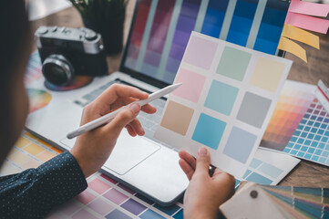 Fototapete - Graphic designer architects who work with laptops and color comparison tables for design work..