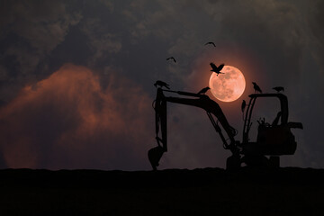 Wall Mural - Silhouette of an excavator parked on the ground with a flock of crows at night with a full red moon.