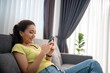 Woman using smart phone and Browsing Internet at home