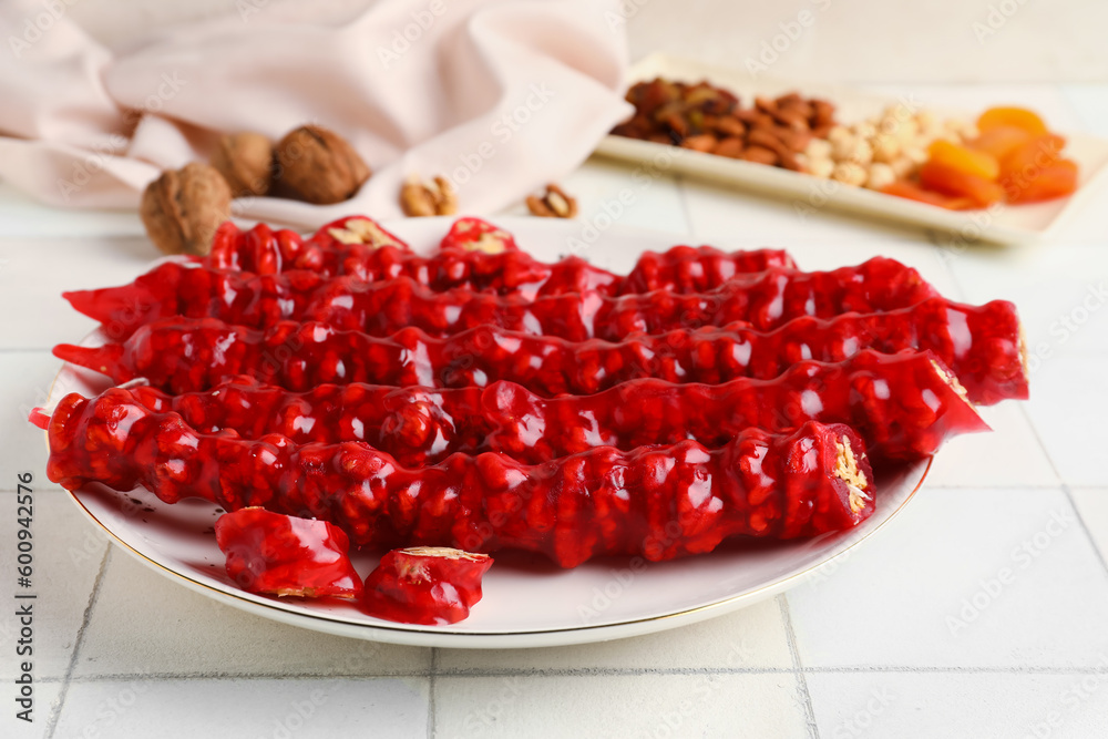 Plate with tasty churchkhela on table