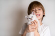 little boy holding a white kitten in his hands, space for text, children and pets