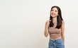 © Chanakon - Beautiful smiling happy young asian woman in brown shirt. Charming female lady standing pose thinking on isolated white blank background. Asian cute people looking copy space for text advertise
