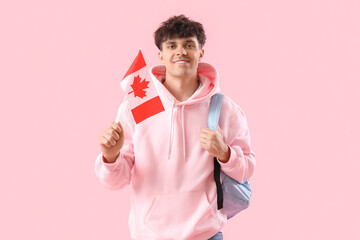 Poster - Young man with flag of Canada and backpack on pink background