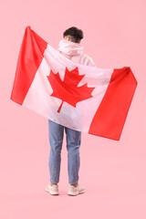 Poster - Young man with flag of Canada on pink background