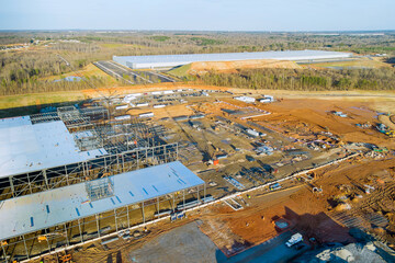 Metal construction frame was installed on construction site to support steel warehouse work done by large crane