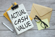 text actual cash value on white notepad paper on work table