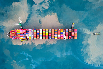 aerial view freight transportation by container ship in open sea.