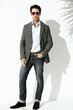 © Lionel Henshaw/peopleimages.com - Cool, sunglasses and portrait of a man with fashion isolated on a white background in a studio. Stylish, young and a model with confidence and fashionable clothes with shades and shadow on backdrop