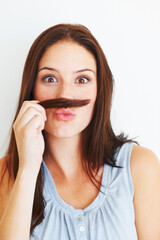 Sticker - Comic, portrait and a woman with hair moustache isolated on a white background in studio. Smile, funny and a young girl being crazy, making face and playing with hairstyle for comedy on a backdrop