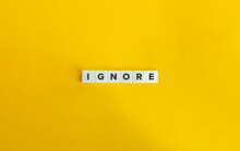 Ignore Word On Block Letter Tiles On Yellow Background. Minimal Aesthetics.