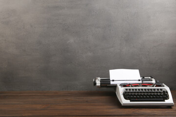 Fototapete - vintage typewriter on the table with blank paper on wooden desk - concept for writing, journalism, blogging