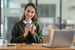 © crizzystudio - Beautiful and confident Asian businesswoman holding a cup of coffee to drink during break Relax with your own business happily in the office.