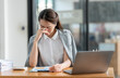 © crizzystudio - Young Asian businesswomen sit stressed out solving various parts of the financial business tasks. administration at her office.