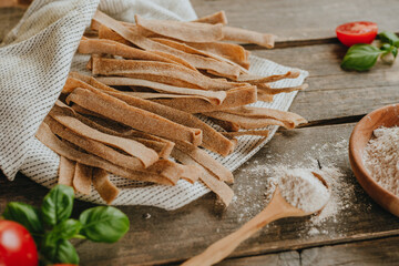 Wall Mural - Handmade raw pasta pappardelle from whole grain flour on rustic backhround